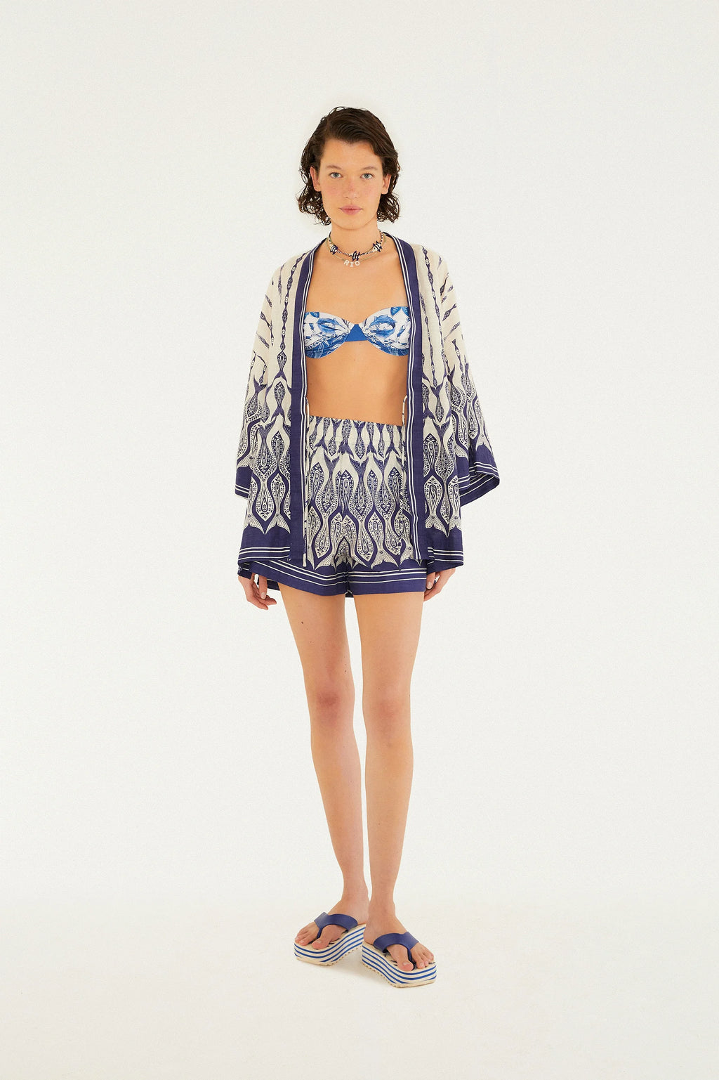 Vista ampla (zoom out) mostrando o look completo com o Kimono Estampado Peixe Correnteza FARM em ambiente natural e iluminado.